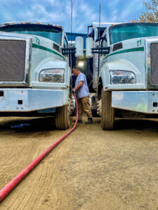 Man fueling tractors with diesel fuel